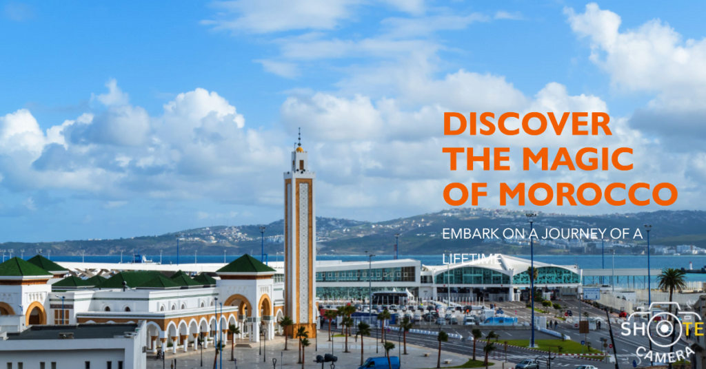 Top Travel Destinations for Photography Enthusiasts 4 A panoramic view of a coastal cityscape under a blue sky with scattered clouds. In the foreground, there’s a large square with a tall minaret and several white buildings with green roofs, indicative of Moroccan architecture. The background features rolling hills and a body of water. Overlaid text in bold reads ‘DISCOVER THE MAGIC OF MOROCCO - EMBARK ON A JOURNEY OF A LIFETIME’ in capital letters, with the watermark ‘ShoteCamera’ at the bottom right corner
